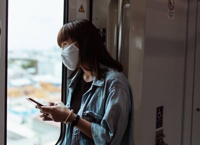 woman looking out train window